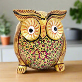 A beautiful hand-painted golden owl figurine made from fine quality Kadamba wood.