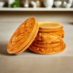 A handmade round powder box made of good quality Kadamba wood with bangle cut-threading on the lid.