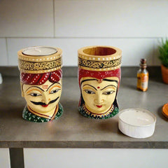 Artistic wooden candle stand representing Kaka and Kaki, with man wearing pagdi and woman in odhani, smokeless candle included.