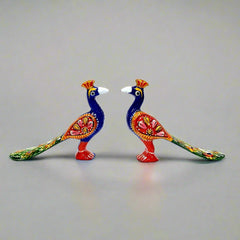 A metal Laddu Gopal toy set with meenakari hand painting, including an elephant and a peacock.
