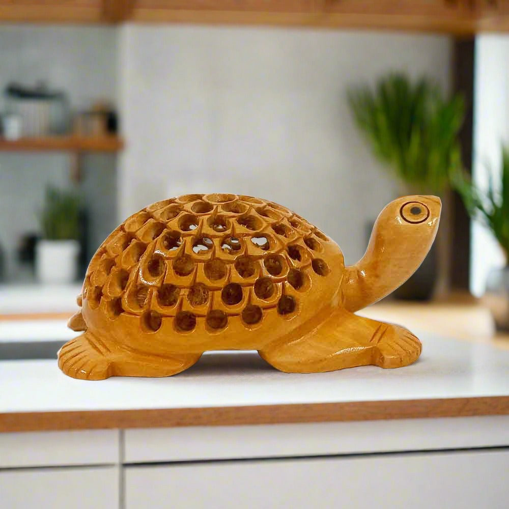 Wood-carved turtle statue with detailed lattice pattern on its shell, ideal for pooja room or home decor.