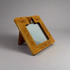 A beautifully designed wooden mirror with intricate lattice work, a great gift for women during festivals.