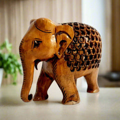 Side view of undercut lattice wooden elephant with antique brown oxidation.
