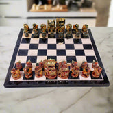 Luxurious wooden chess set decorated with intricate hand painting, featuring red and green traditional Indian color theme.