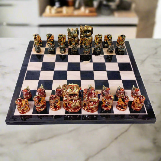 Luxurious wooden chess set decorated with intricate hand painting, featuring red and green traditional Indian color theme.