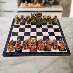 Luxurious wooden chess set decorated with intricate hand painting, featuring red and green traditional Indian color theme.