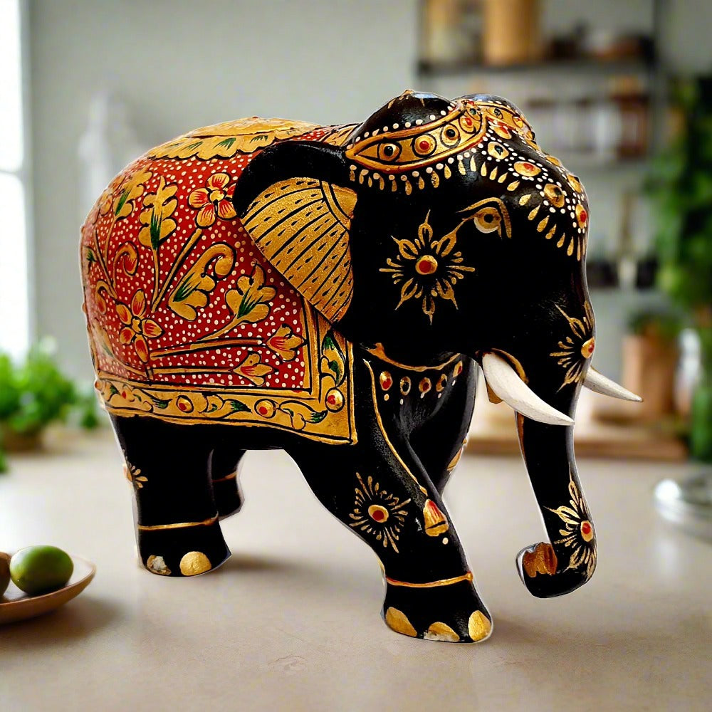 Luxury wooden elephant statue with black paint and golden floral emboss artwork, suitable for home decoration