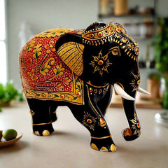 Luxury wooden elephant statue with black paint and golden floral emboss artwork, suitable for home decoration