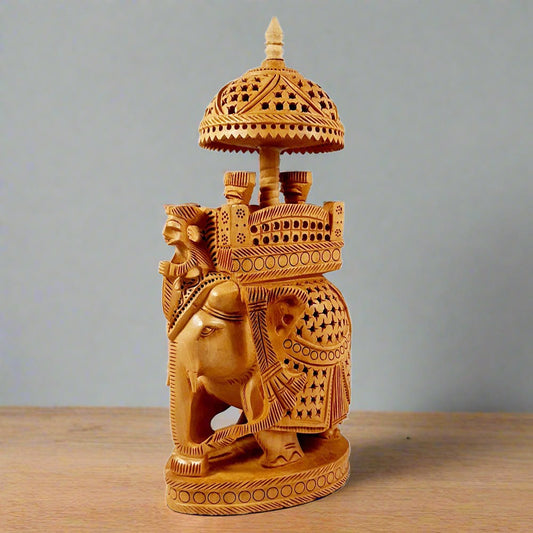Magnificent wooden Ambabari elephant idol featuring a palanquin with king and queen figures, traditionally crafted.