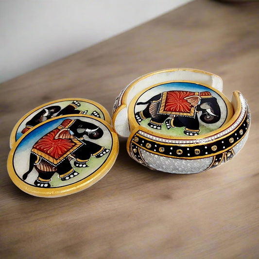 Round marble coaster set with hand-painted elephant designs and studded white kundan embellishments