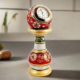 A beautiful marble pillar clock with a round dial, decorated with hand painting and studded with kundan work.