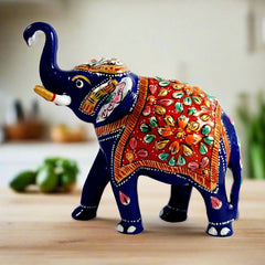 A beautiful Meenakari metal elephant statue with a high trunk, considered lucky for home and office.
