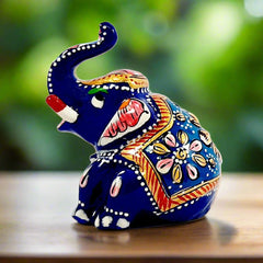 A cute metal Appu elephant statue with wonderful Meenakari painting on it.