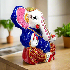 Metal Ganesha idol decorated with vibrant meenakari paintings, showing blessings gesture and intricate facial features