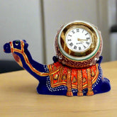 A table clock made with a metal camel and a marble clock, decorated with enamel paint.
