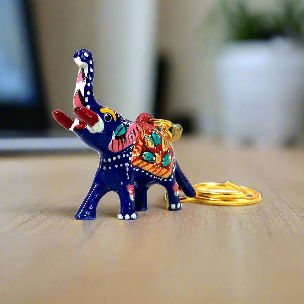 A metal Meenakari elephant keychain with a high trunk, considered a symbol of good luck.