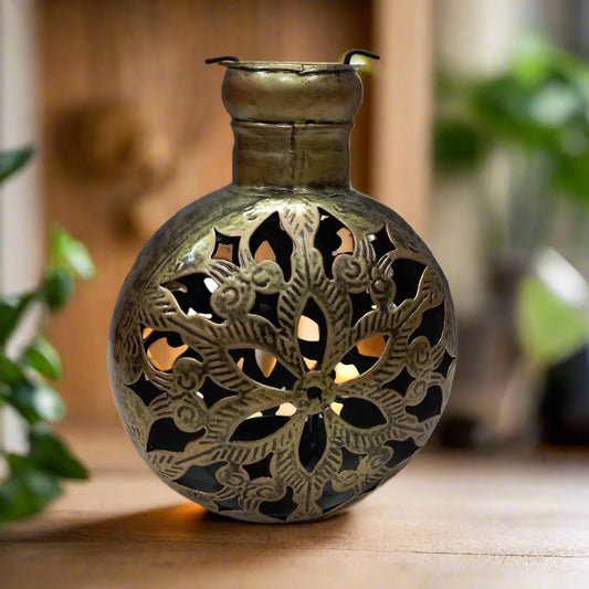 A beautiful metal T-light candle holder with a stunning mesh design and golden oxidized painting.