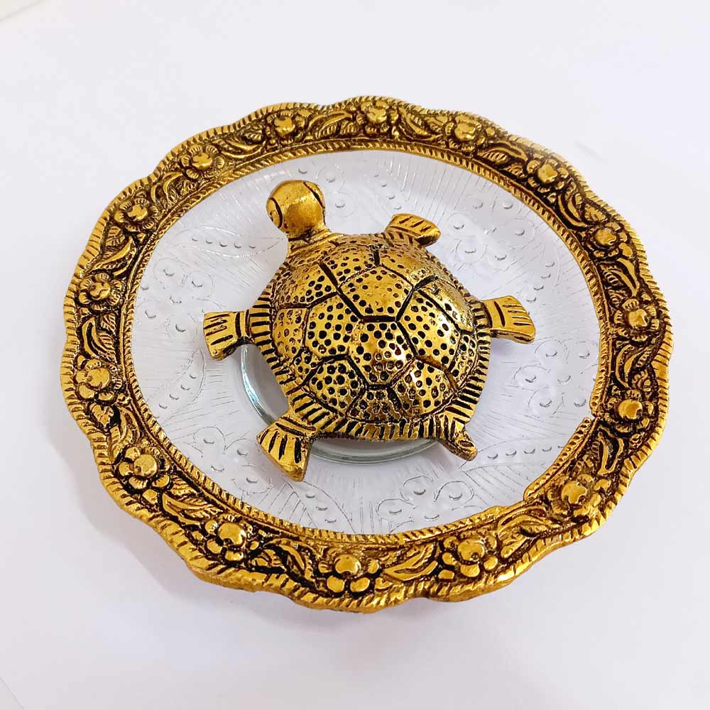 Metal and glass Vastu tortoise with carved border around glass bowl, symbolizing positivity