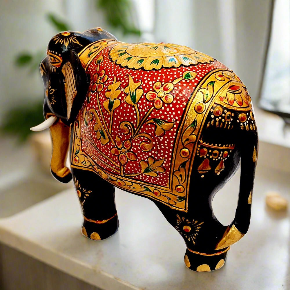 Painted wooden elephant featuring floral emboss design in gold over red background, perfect decorative and gift item