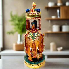 Painted wooden elephant showpiece with a king (maharaja) riding on a pavilion.