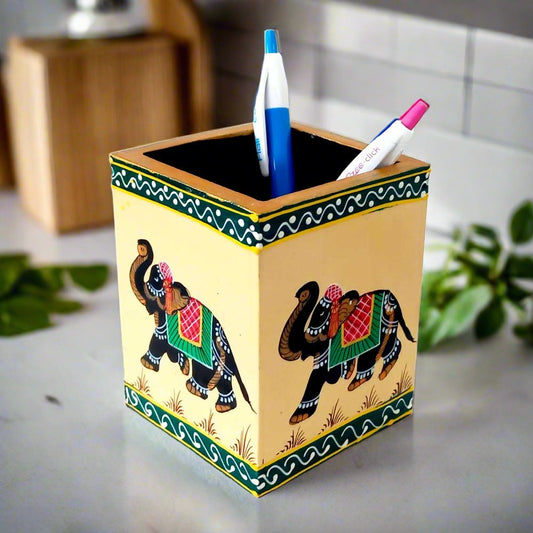 A beautiful painted wooden pen holder with miniature elephant figures, a great office gift.