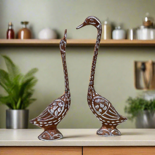 Pair of swans made from fine quality white metal, polished with copper and silver, symbolizing love and elegance.