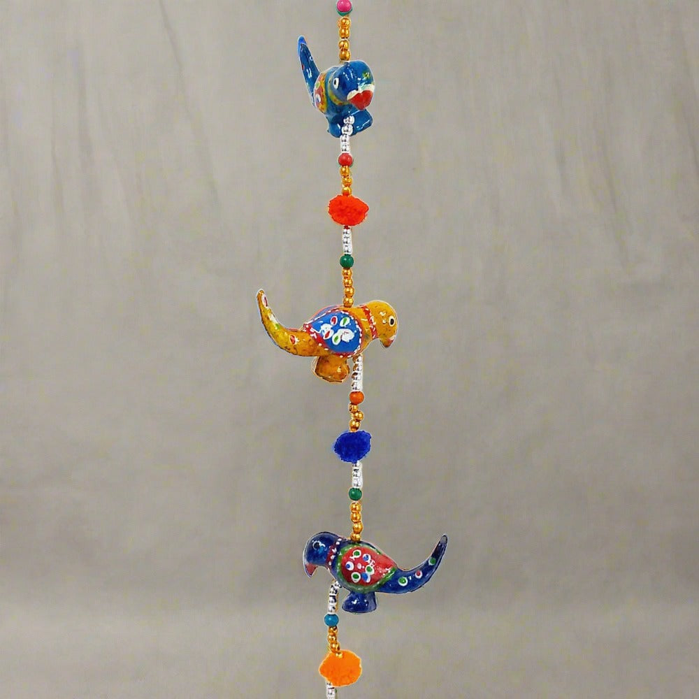 A beautiful papermache toran door hanging with a parrot design.