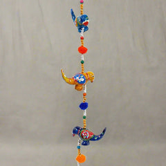 A beautiful papermache toran door hanging with a parrot design.