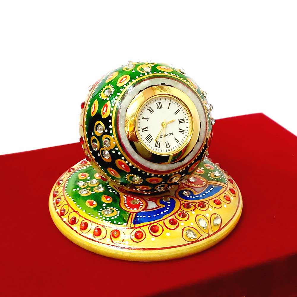 A beautiful hand-painted pure marble ball-shaped clock, placed on a marble plate.