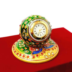 A beautiful hand-painted pure marble ball-shaped clock, placed on a marble plate.