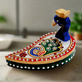 A beautiful hand-painted kumkum box made of pure marble with a peacock design.