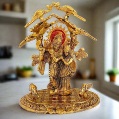Intricately detailed metal Radha Krishna idol with elegant tree and peacock design