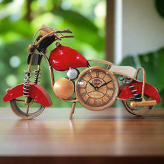Royal Enfield bike clock made of metal with antique painting, placed on a desk.