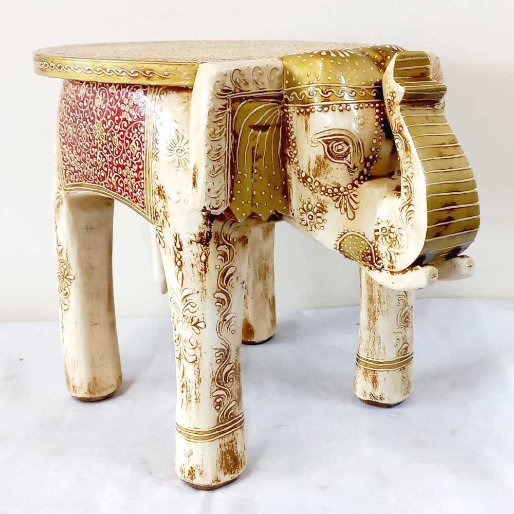 A royal-looking elephant stool made of fine quality wood, suitable for children and adults to sit on.