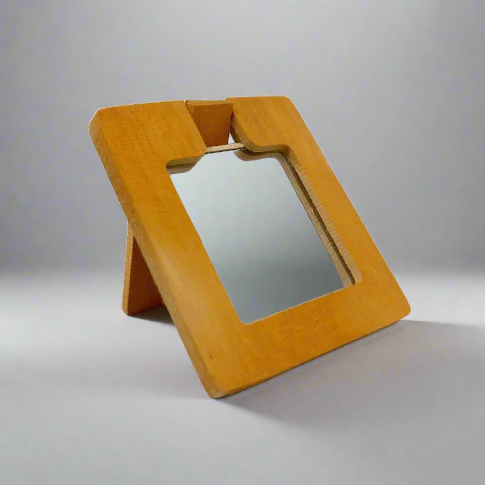 A square-shaped wooden hand mirror with an elephant design.