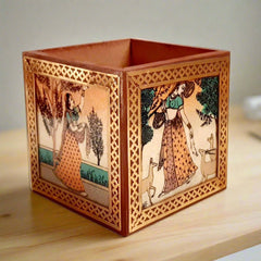 A square wooden desk organizer featuring beautiful gemstone painting all around.