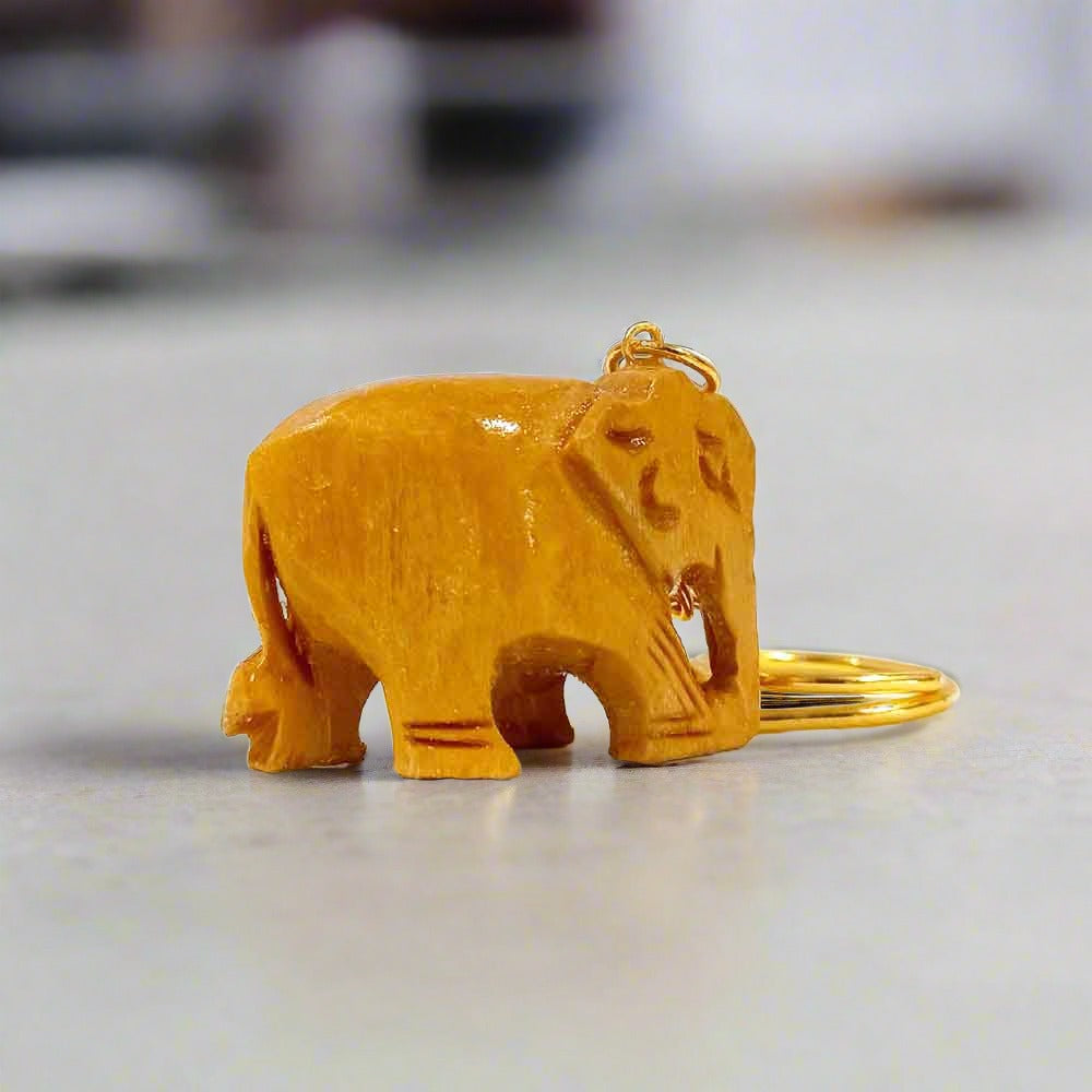 A wood carving of a symbolic elephant for a key ring, representing strength, wisdom, and loyalty.