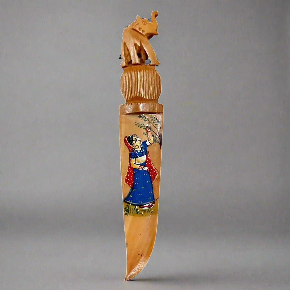 A traditional Rajasthani art letter opener made of wood, a unique desk accessory.