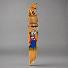 A traditional Rajasthani art letter opener made of wood, a unique desk accessory.