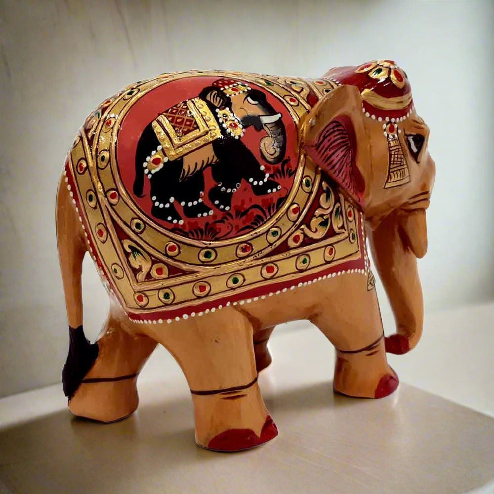 A traditional wood elephant statue with embossed painting on both sides.