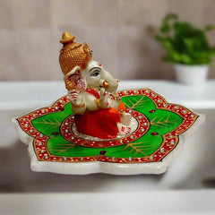A unique marble Ganpati figurine seated on a lotus, with a beautiful design.