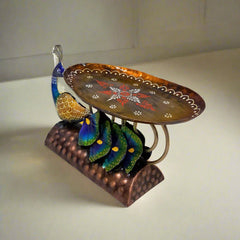 Vibrant metal peacock platter decorated with hand painting, adding charm and color to kitchen or dining areas.