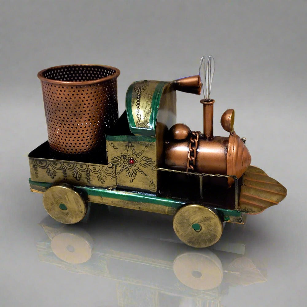 Vintage metal pen stand in train shape, artisan painted by hand, adding charm to any office table.