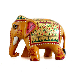 Wooden elephant statue with floral designs in red and green painted on gold, ideal for gifting and interior decor