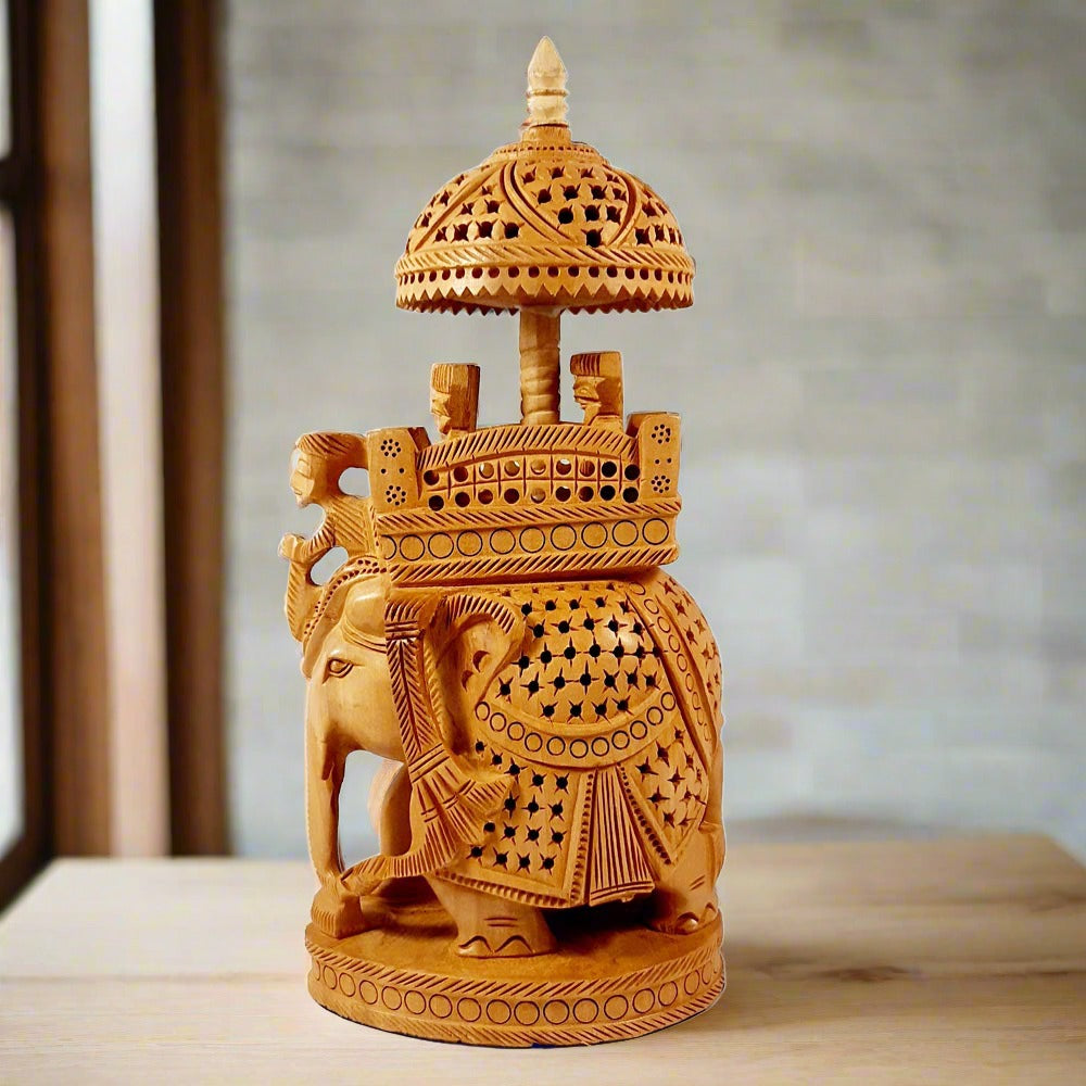 Handmade traditional Ambabari elephant figurine in wood, showing the mahout and royal riders in palanquin.