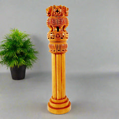 A handcrafted wooden Ashoka Pillar with four lions standing back to back, representing the Lion Capital of India.