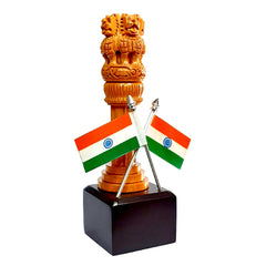 Decorative wooden Ashoka Pillar on brown platform with flags, symbolizing India's heritage