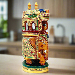 A wooden carved elephant with a king and a mahout, a beautiful showpiece reminiscent of the Mughal era.