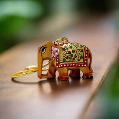 A wooden elephant keyring with a sturdy golden ring, best for gifting and personal use.