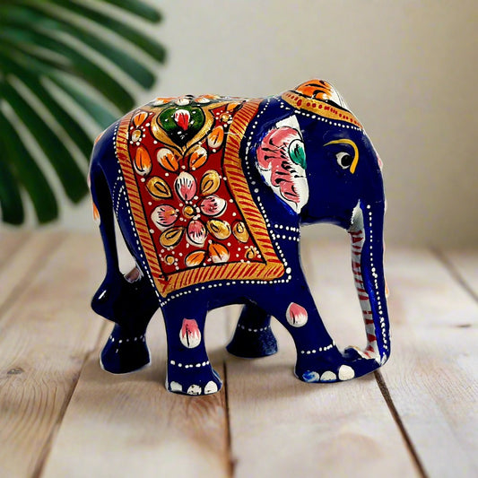 A fabulous wooden elephant statue with a low trunk and intricate Meenakari painting.